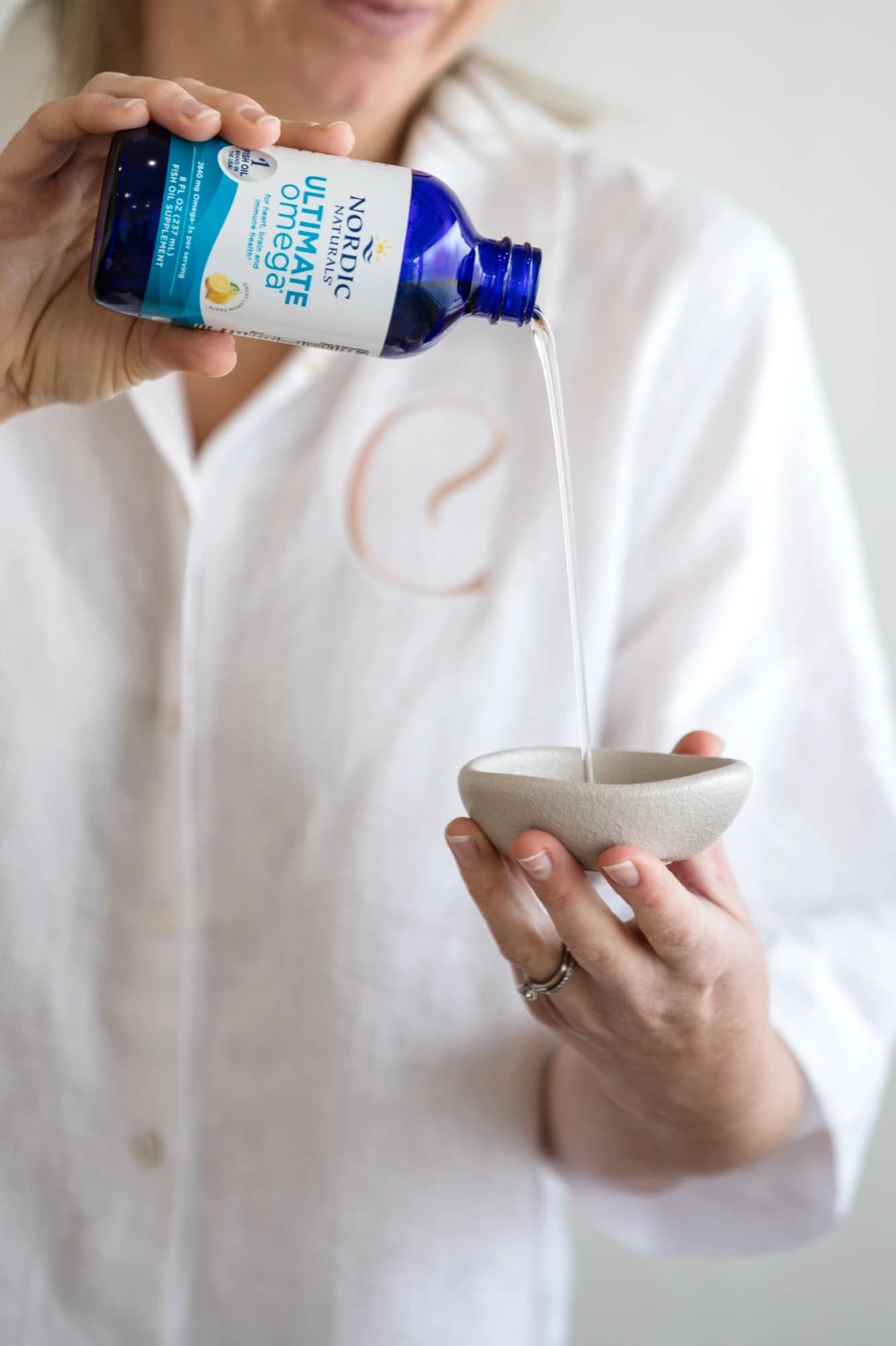 An omega supplement being poured into a ceramic dish at Classic Skin in Echuca