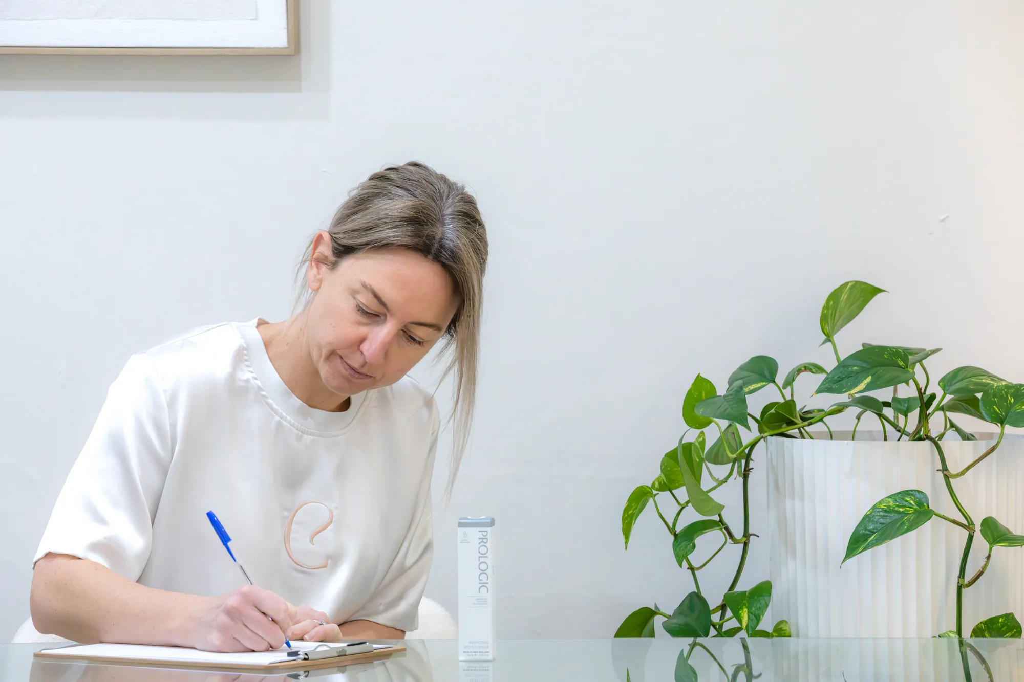 Amber Brown writing a personalised skin plan during a consultation in Echuca